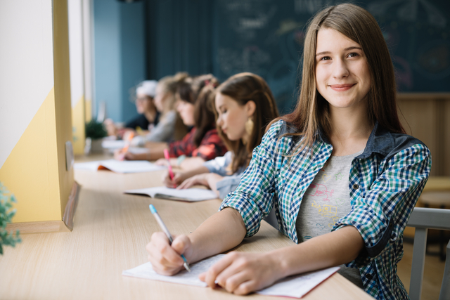 cheerful teen girl student with classmates