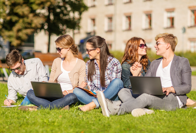 summer, internet, education, technlogy and campus concept - group of students or teenagers with laptop, notebooks, files and folders