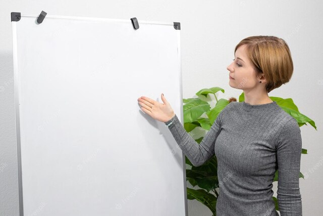 young woman is standing bright room pointing blank flip chart online teacher tutor 752567 811
